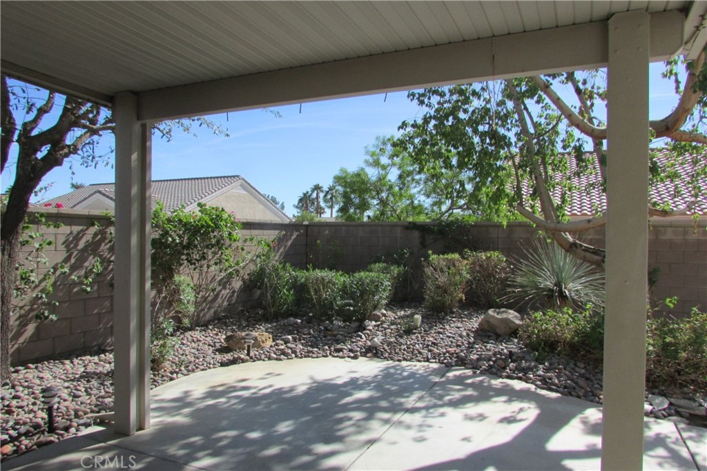 78281 Bovee Circle Palm Desert, CA 92211 - Photo 26 of 38 a view of a yard with plants and a wooden bench
