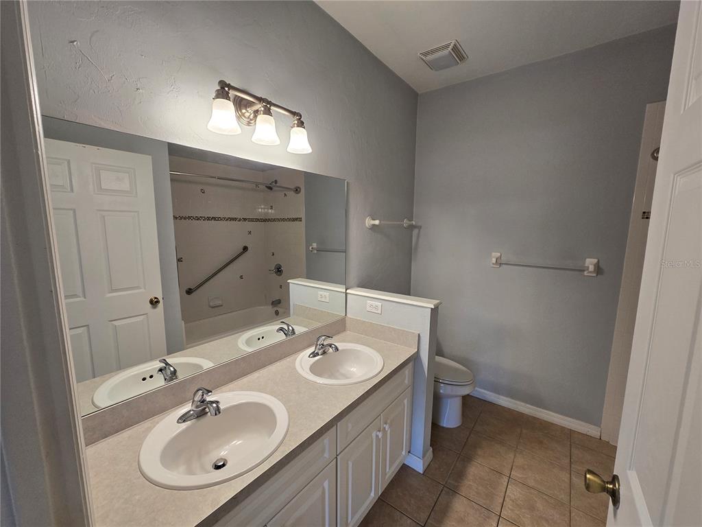 7976 48 Way Gainesville, FL 32653 - Photo 10 of 26 a bathroom with a sink double vanity and a mirror