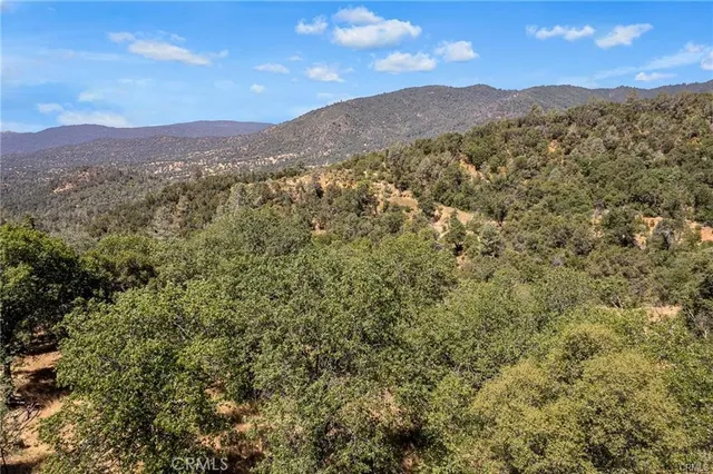 a view of a mountain range with lush green hillside