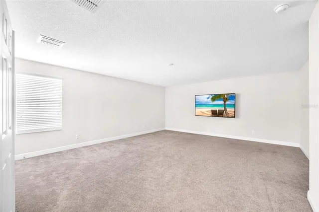 an empty room with windows and painted walls