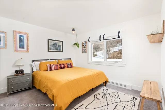 a bedroom with bed and a window