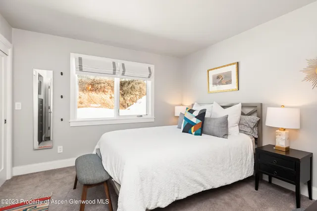 a bedroom with a bed and a television