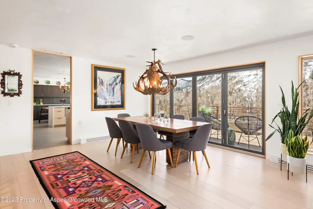 a view of a dining room with furniture wooden floor and chandelier