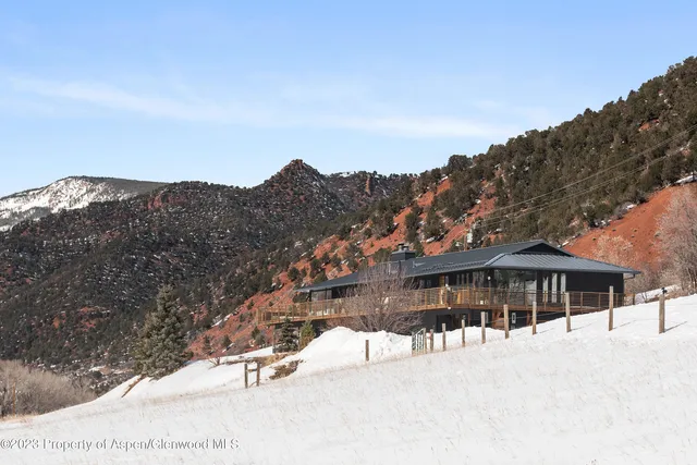 a view of a terrace with a table and chairs