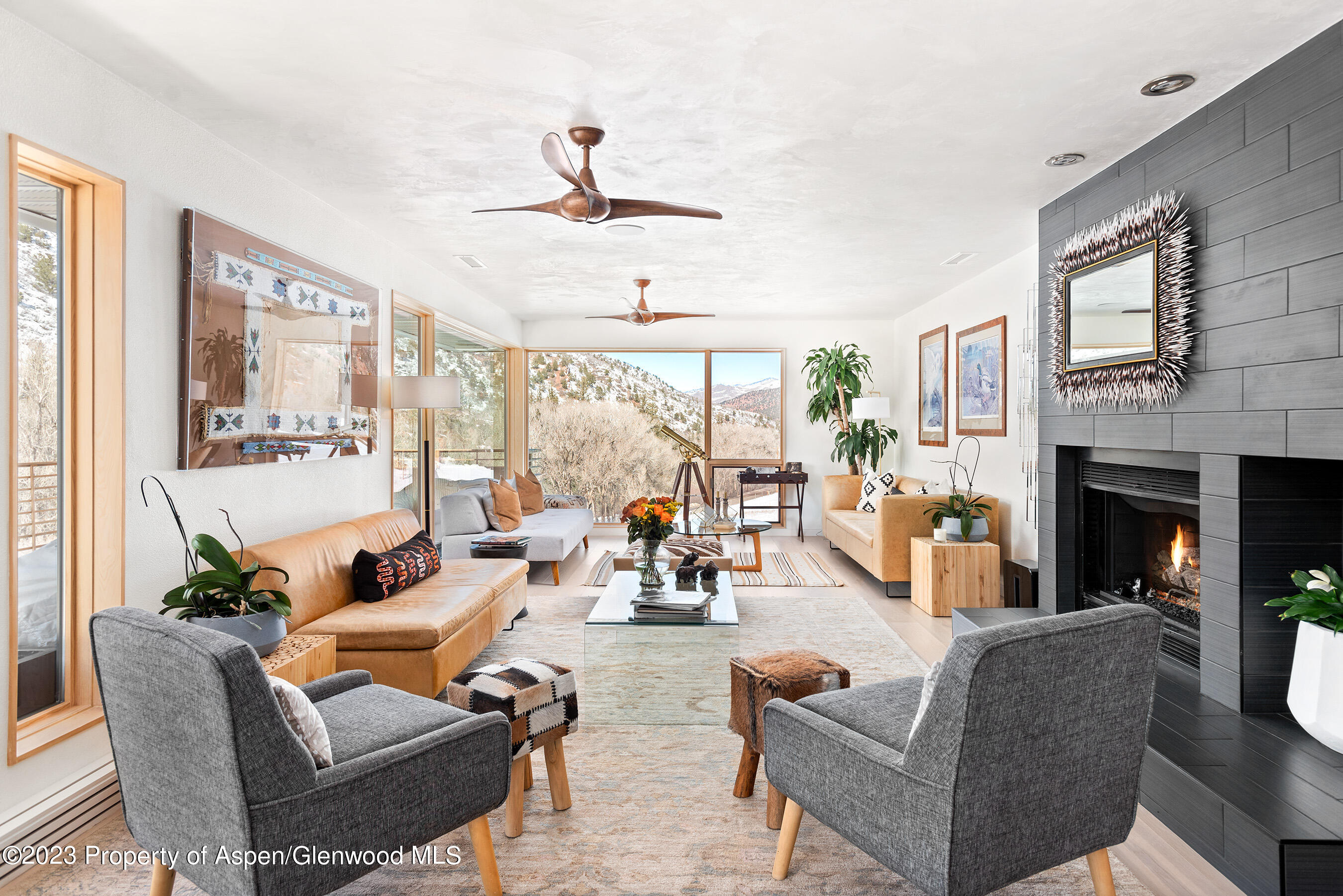 876 Snowmass Creek Road Snowmass, CO 81654 - Photo 5 of 40 a living room with furniture fireplace and a large window