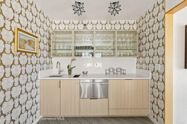 a view of a dining room with furniture and chandelier