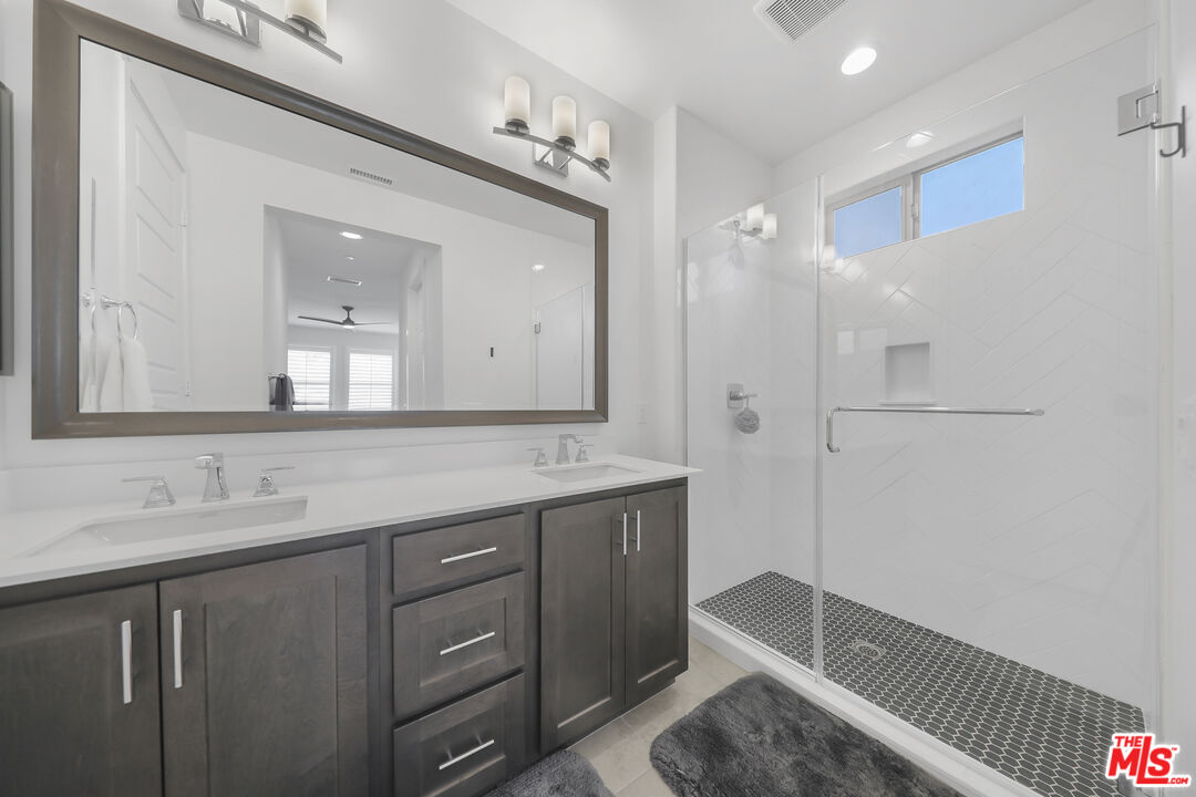 73500 Henri Drive Palm Desert, CA 92211 - Photo 15 of 28 a bathroom with a double vanity sink mirror and shower