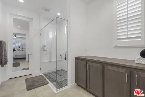 a spacious bathroom with a granite countertop sink and a mirror