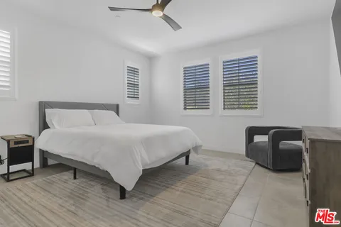a bedroom with a bed and a chair