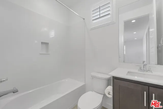 a bathroom with a sink a toilet and bathtub