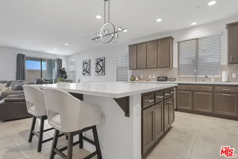 a kitchen with a counter space a sink appliances and cabinets