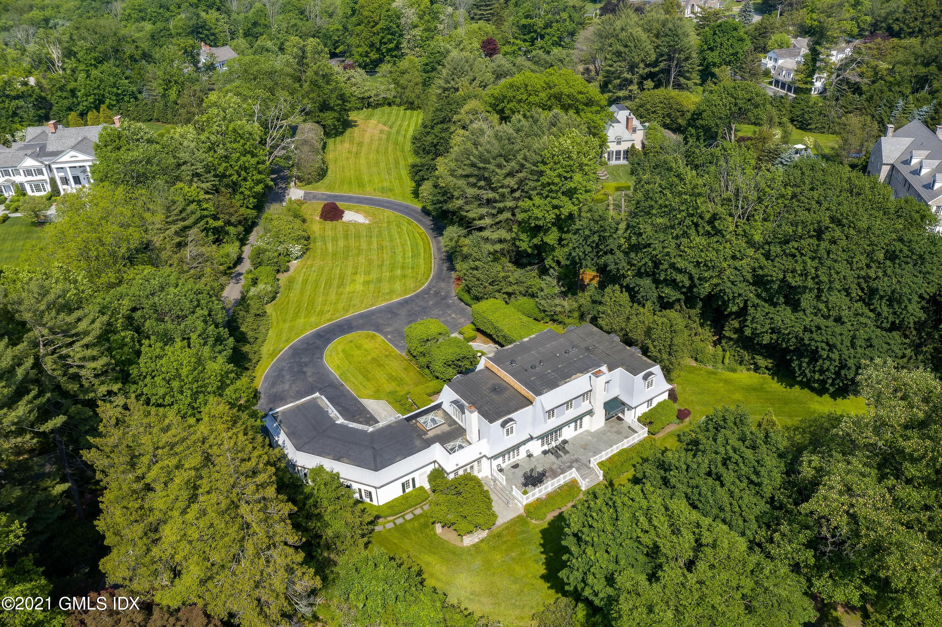 an aerial view of a house with a swimming pool and outdoor seating