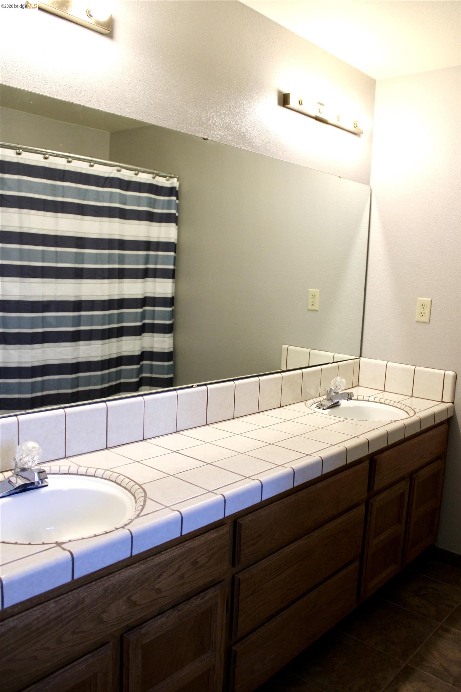 13033 Clements Road Groveland, CA 95321 - Photo 15 of 23 Bathroom featuring double vanity and a shower with curtain