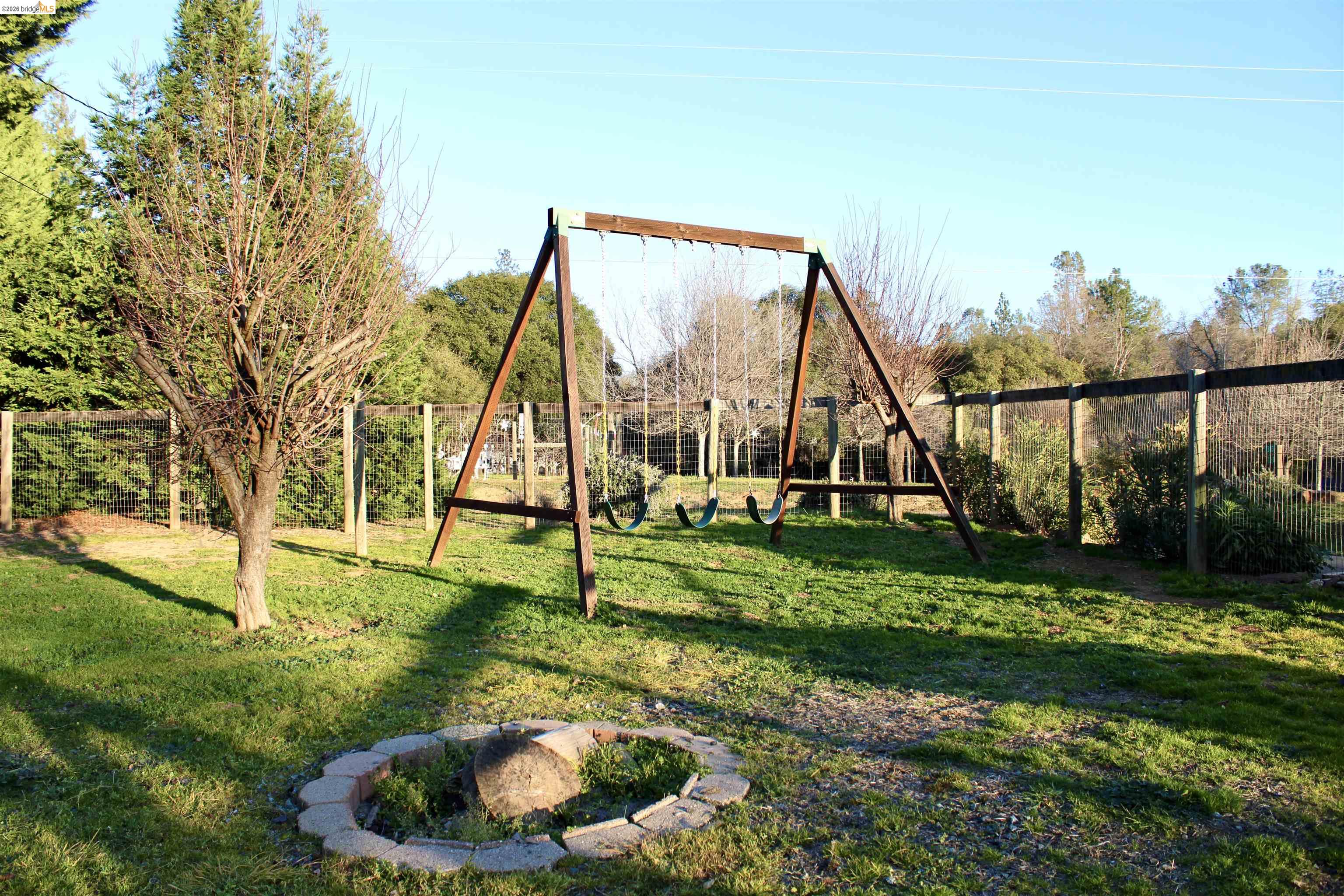 13033 Clements Road Groveland, CA 95321 - Photo 7 of 23 View of yard with a playground and an outdoor fire pit
