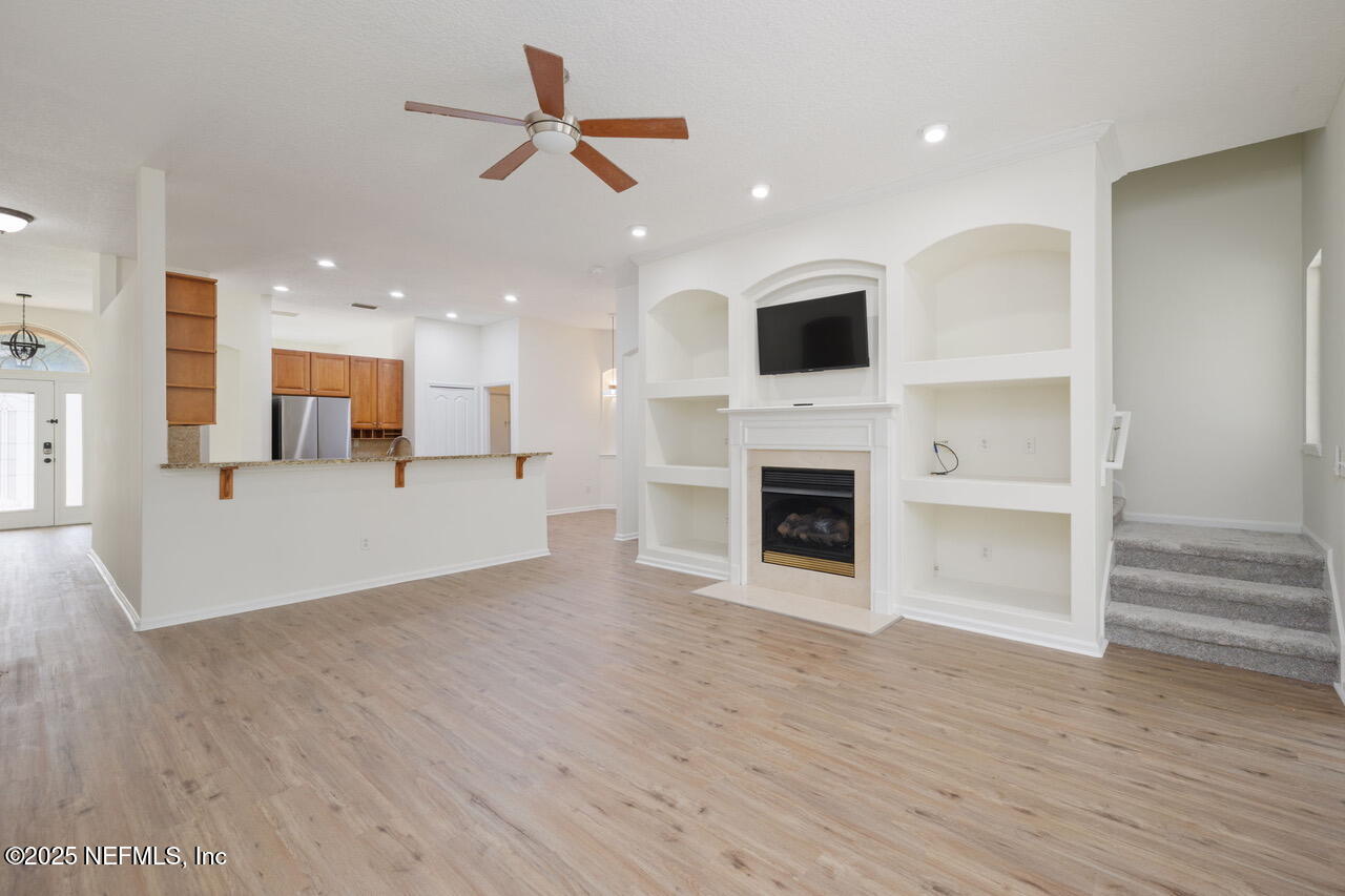 1140 Eddystone Lane Ponte Vedra, FL 32081 - Photo 12 of 29 a view of a living room with wooden floor and a fireplace