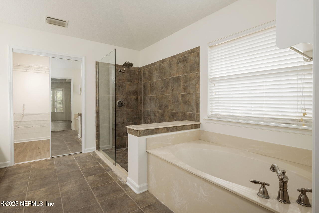 1140 Eddystone Lane Ponte Vedra, FL 32081 - Photo 15 of 29 a bathroom with a bathtub and a shower