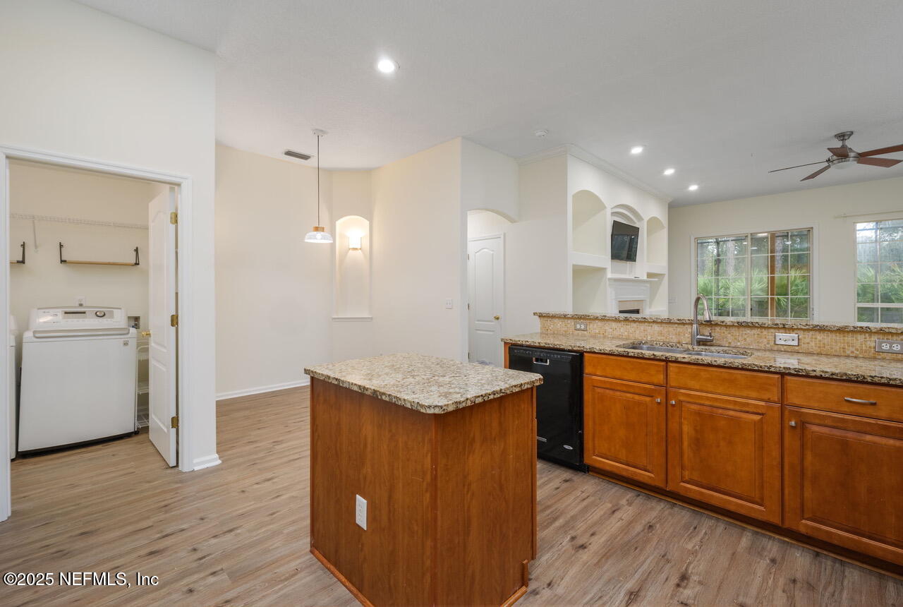 1140 Eddystone Lane Ponte Vedra, FL 32081 - Photo 7 of 29 a kitchen with granite countertop cabinets sink and wooden floor