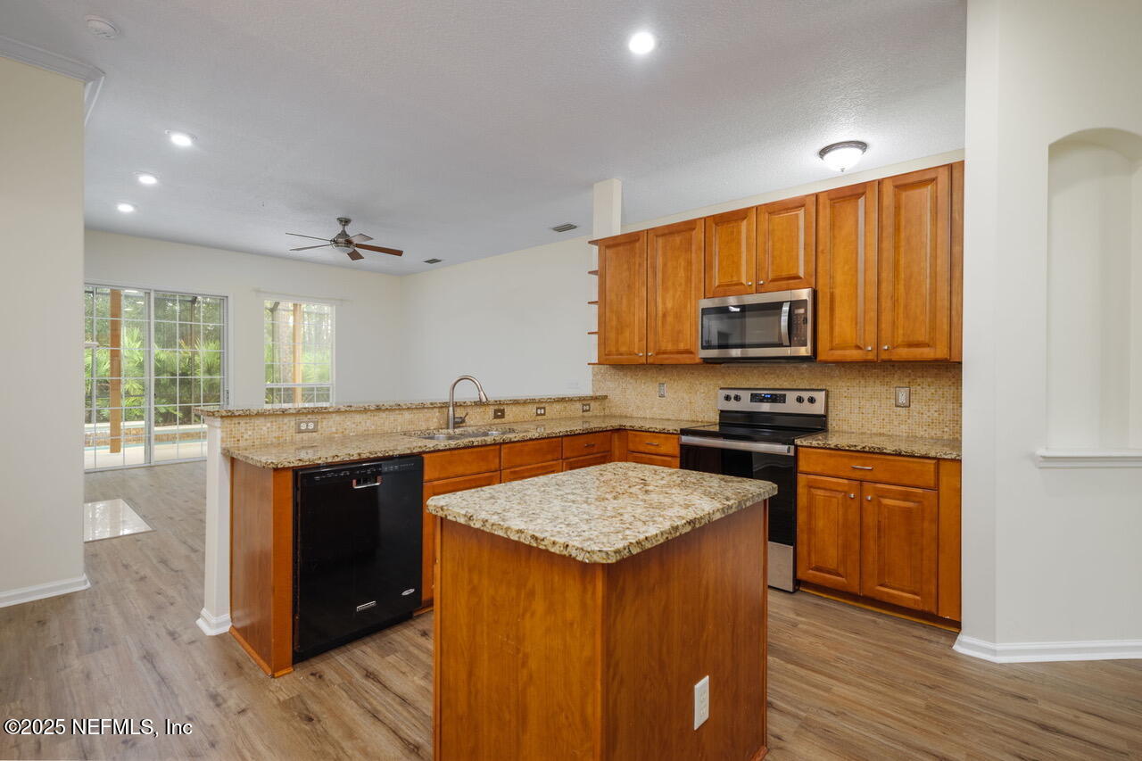 1140 Eddystone Lane Ponte Vedra, FL 32081 - Photo 10 of 29 a kitchen with a stove a sink and a microwave