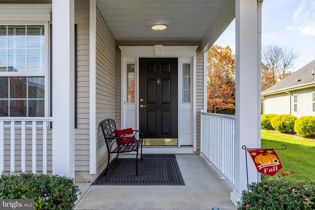 a view of front door of house with outdoor seating space