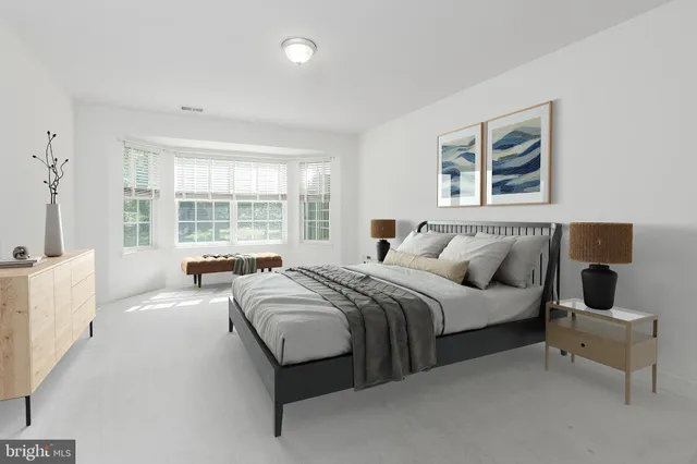 a bedroom with a bed and a couch