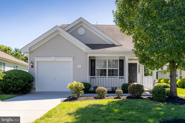 a front view of a house with a yard and outdoor seating