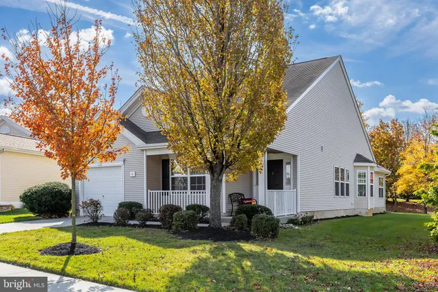 a view of a house with pool and sitting area