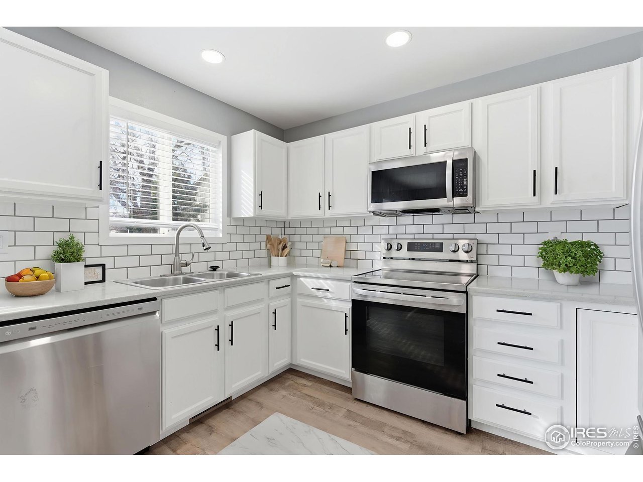 357 Albion Way, Unit 4 Fort Collins, CO 80526 - Photo 12 of 28 a kitchen with stainless steel appliances granite countertop a stove a sink and a microwave