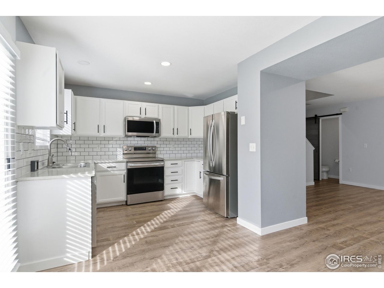 357 Albion Way, Unit 4 Fort Collins, CO 80526 - Photo 13 of 28 a kitchen with granite countertop a refrigerator stove and oven