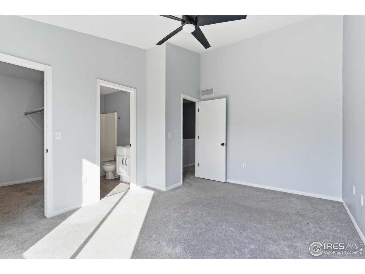 357 Albion Way, Unit 4 Fort Collins, CO 80526 - Photo 17 of 28 a view of a room with a ceiling fan and carpet