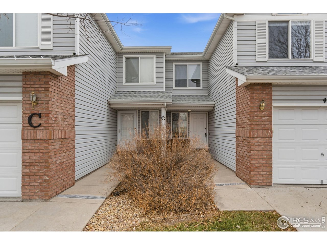 357 Albion Way, Unit 4 Fort Collins, CO 80526 - Photo 4 of 28 a view of a house with a small yard and wooden floor and fence