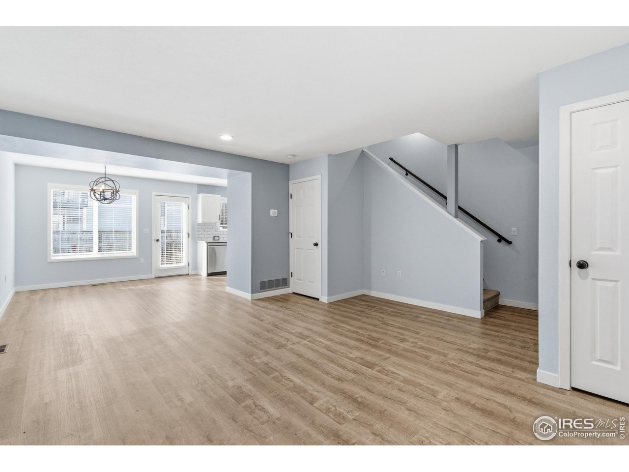 357 Albion Way, Unit 4 Fort Collins, CO 80526 - Photo 8 of 28 a view of an empty room with wooden floor and stairs