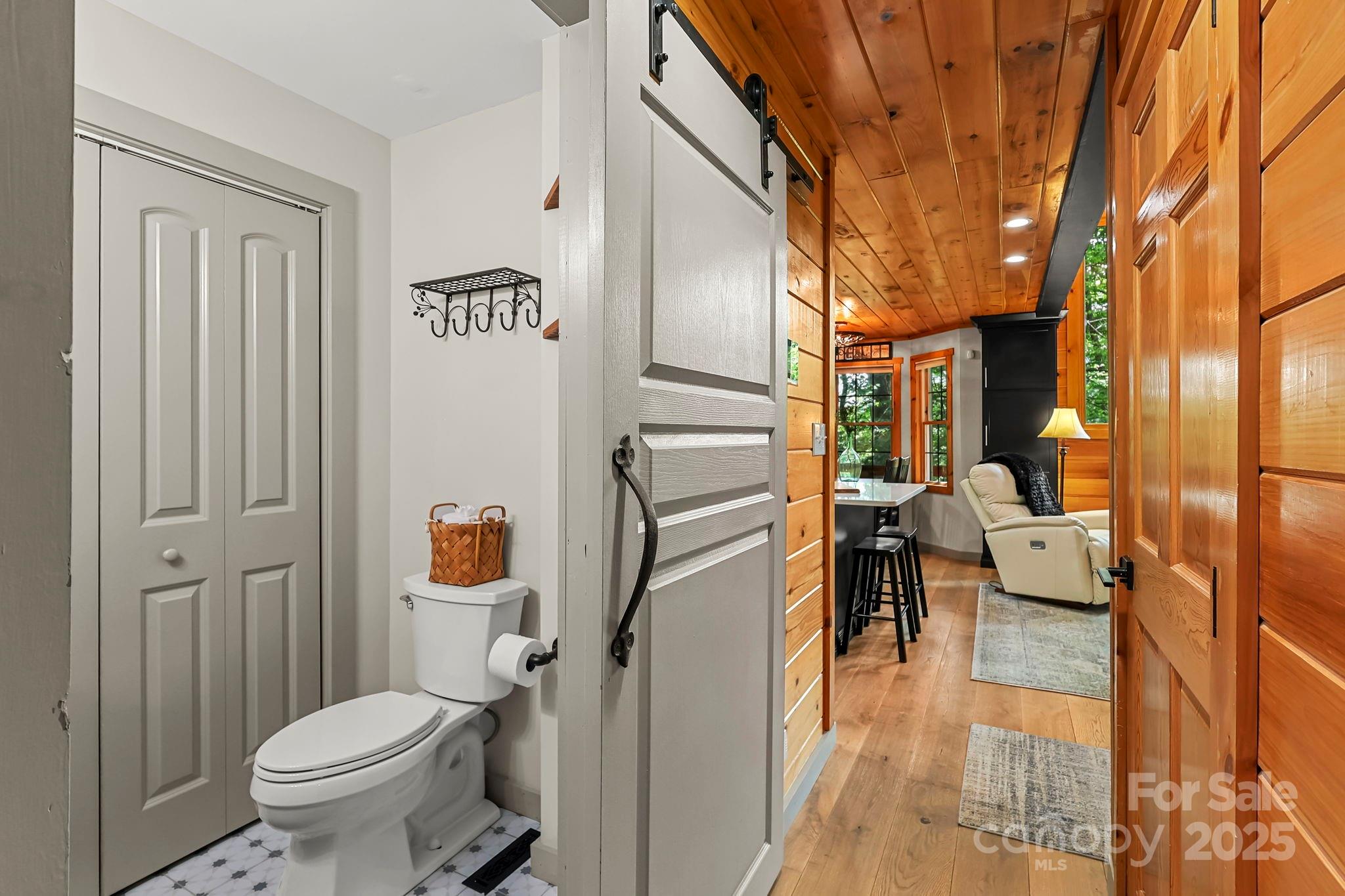 228 Woodby Ridge Road Vilas, NC 28692 - Photo 16 of 46 a bathroom with a toilet sink and mirror