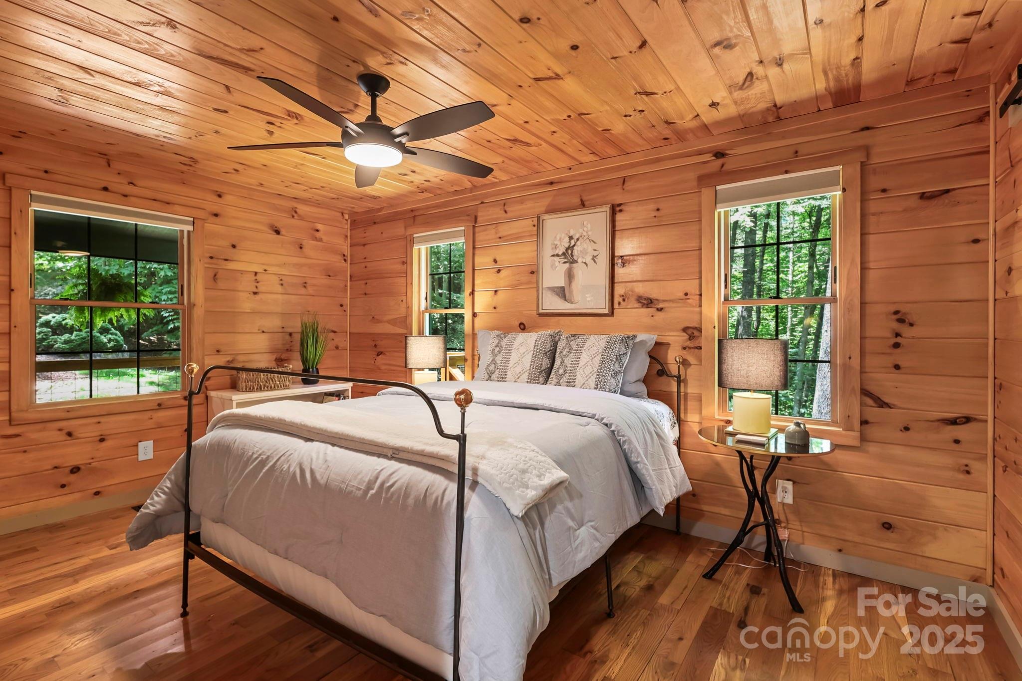 228 Woodby Ridge Road Vilas, NC 28692 - Photo 18 of 46 a bed sitting in a spacious bedroom next to a window