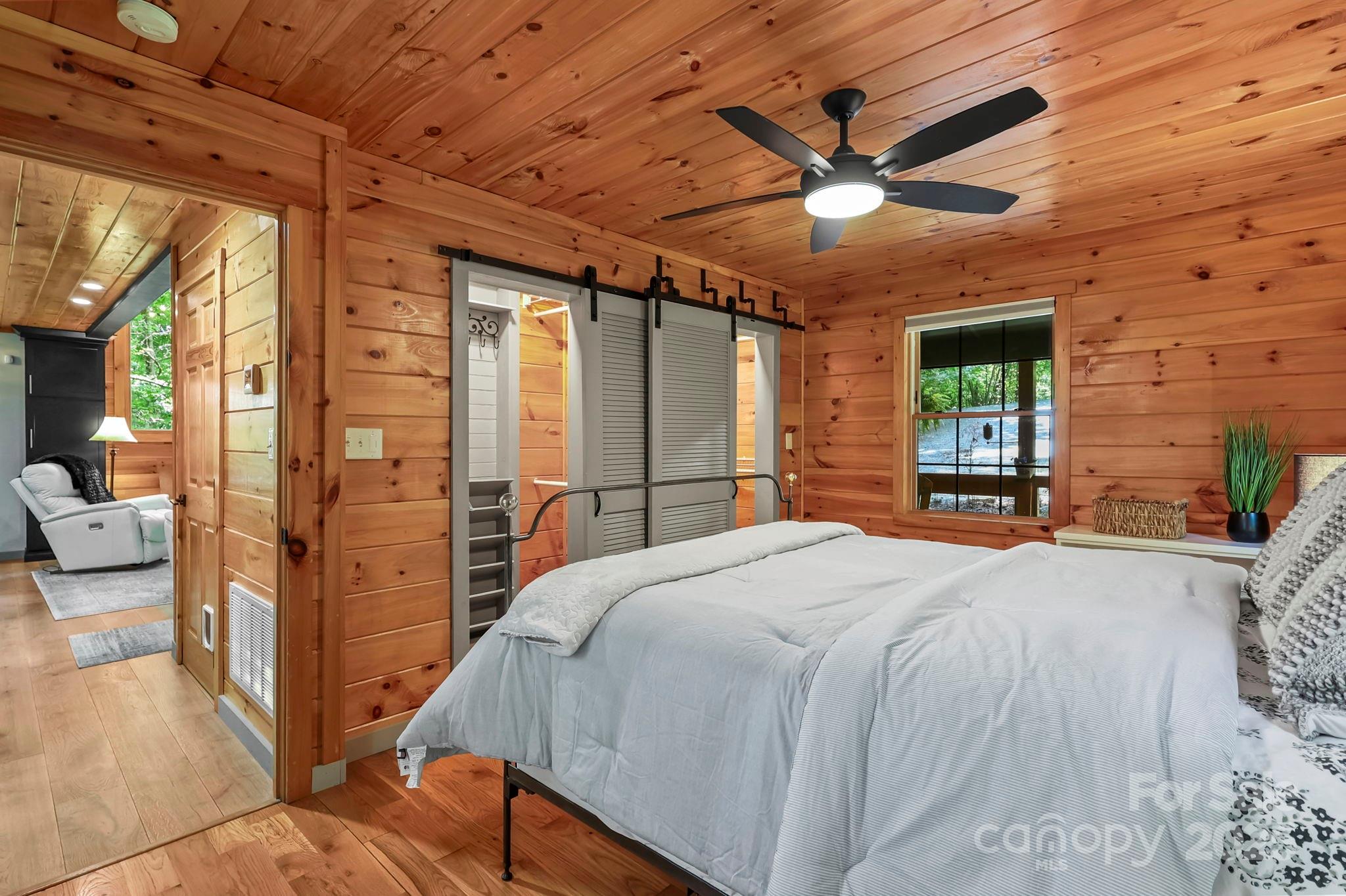 228 Woodby Ridge Road Vilas, NC 28692 - Photo 19 of 46 a bedroom with a bed and a large mirror