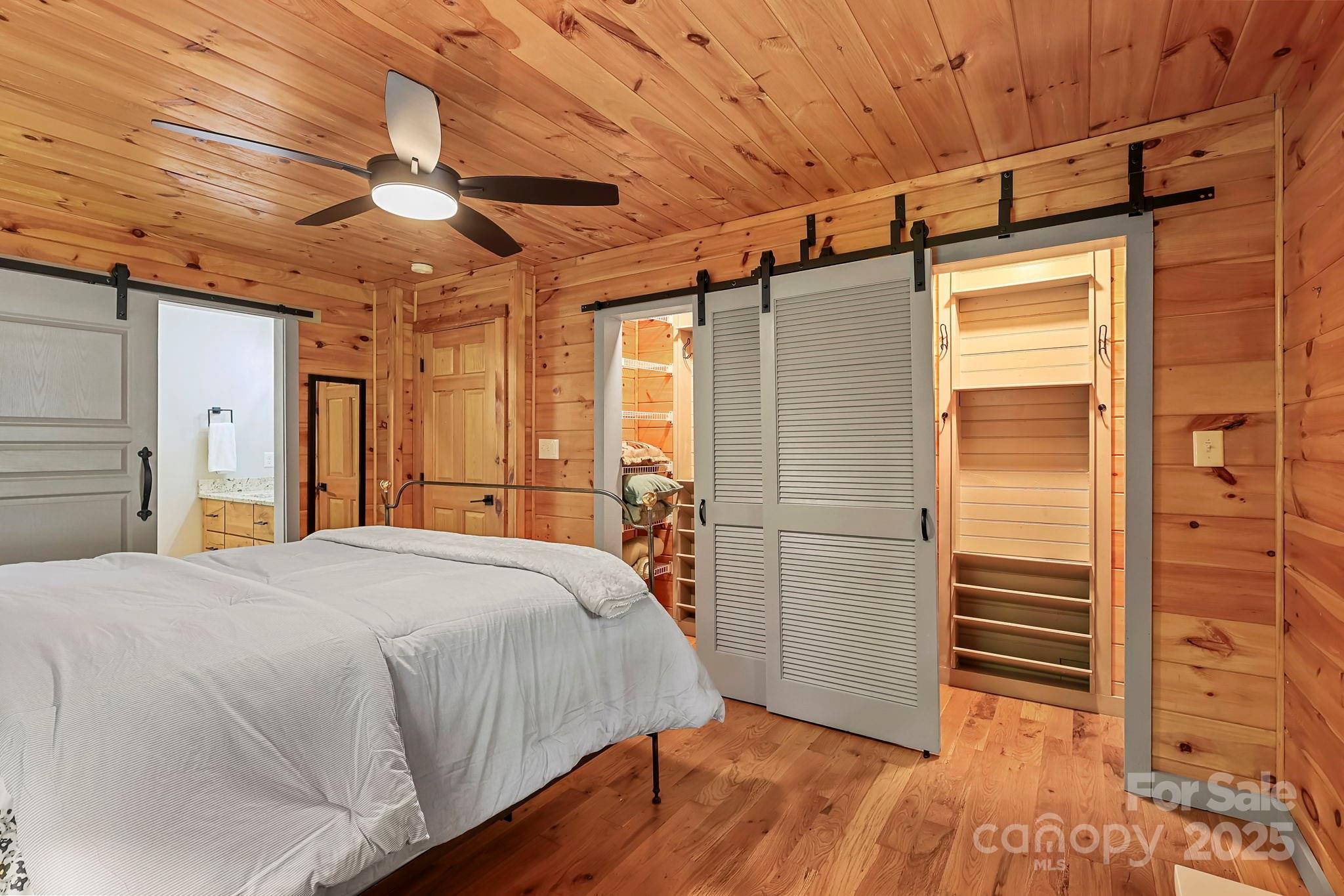 228 Woodby Ridge Road Vilas, NC 28692 - Photo 20 of 46 a bedroom with a bed and a walk in closet