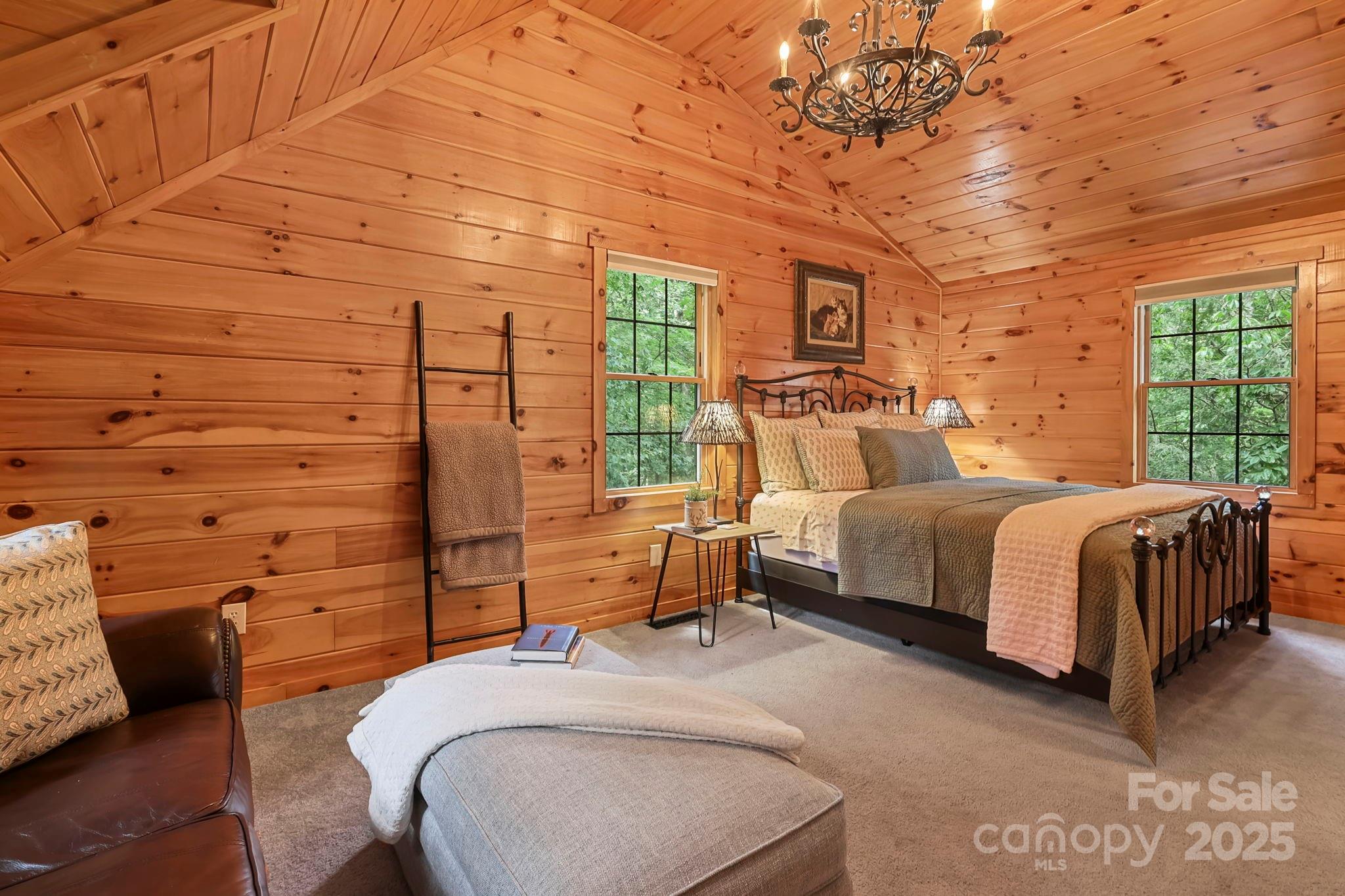 228 Woodby Ridge Road Vilas, NC 28692 - Photo 28 of 46 a bedroom with a bed and wooden floor