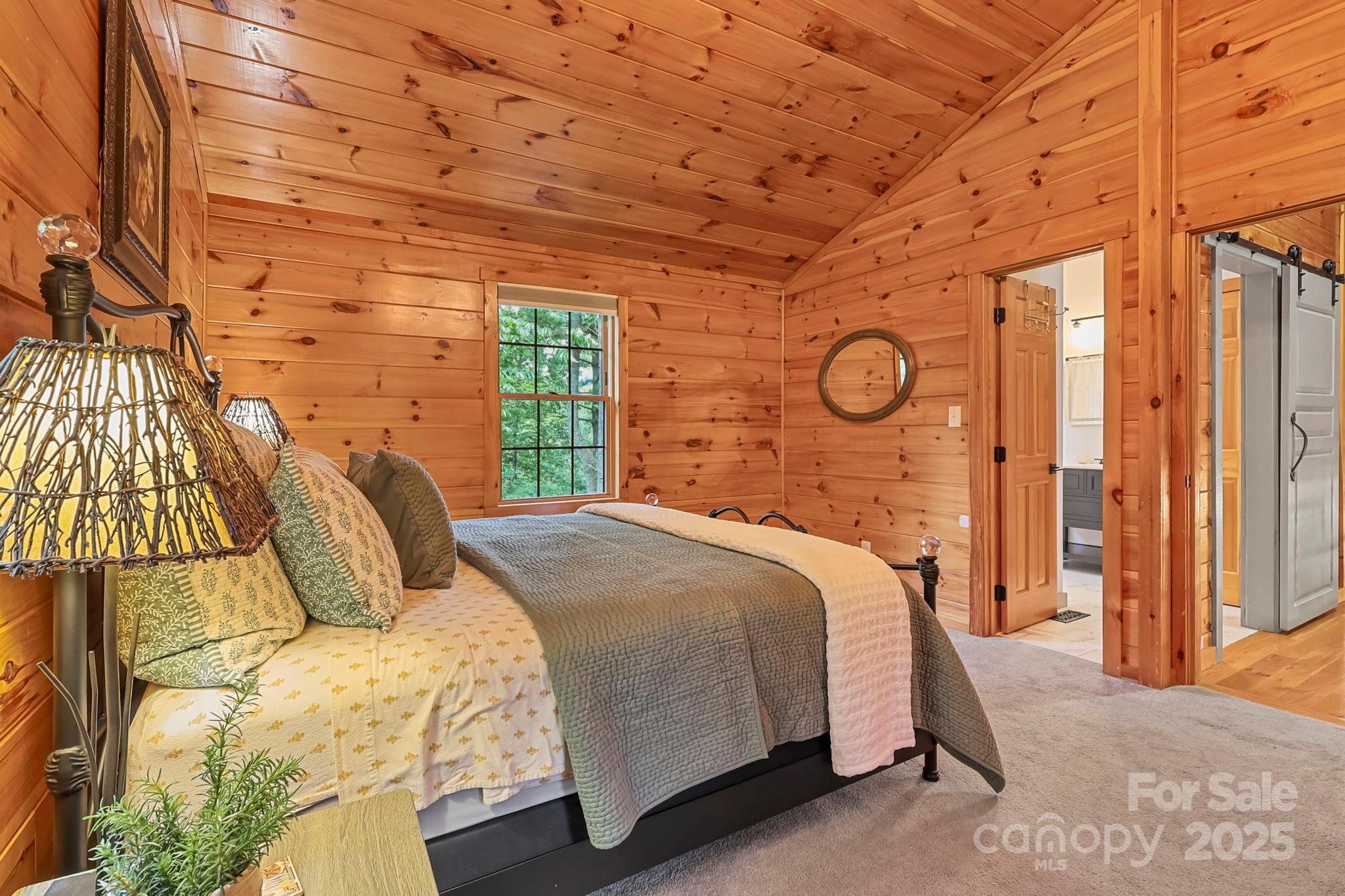 228 Woodby Ridge Road Vilas, NC 28692 - Photo 29 of 46 a bedroom with a bed and a night stand