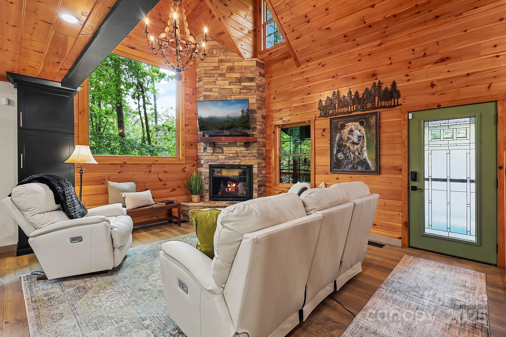 228 Woodby Ridge Road Vilas, NC 28692 - Photo 5 of 46 a living room with furniture a fireplace and a flat screen tv