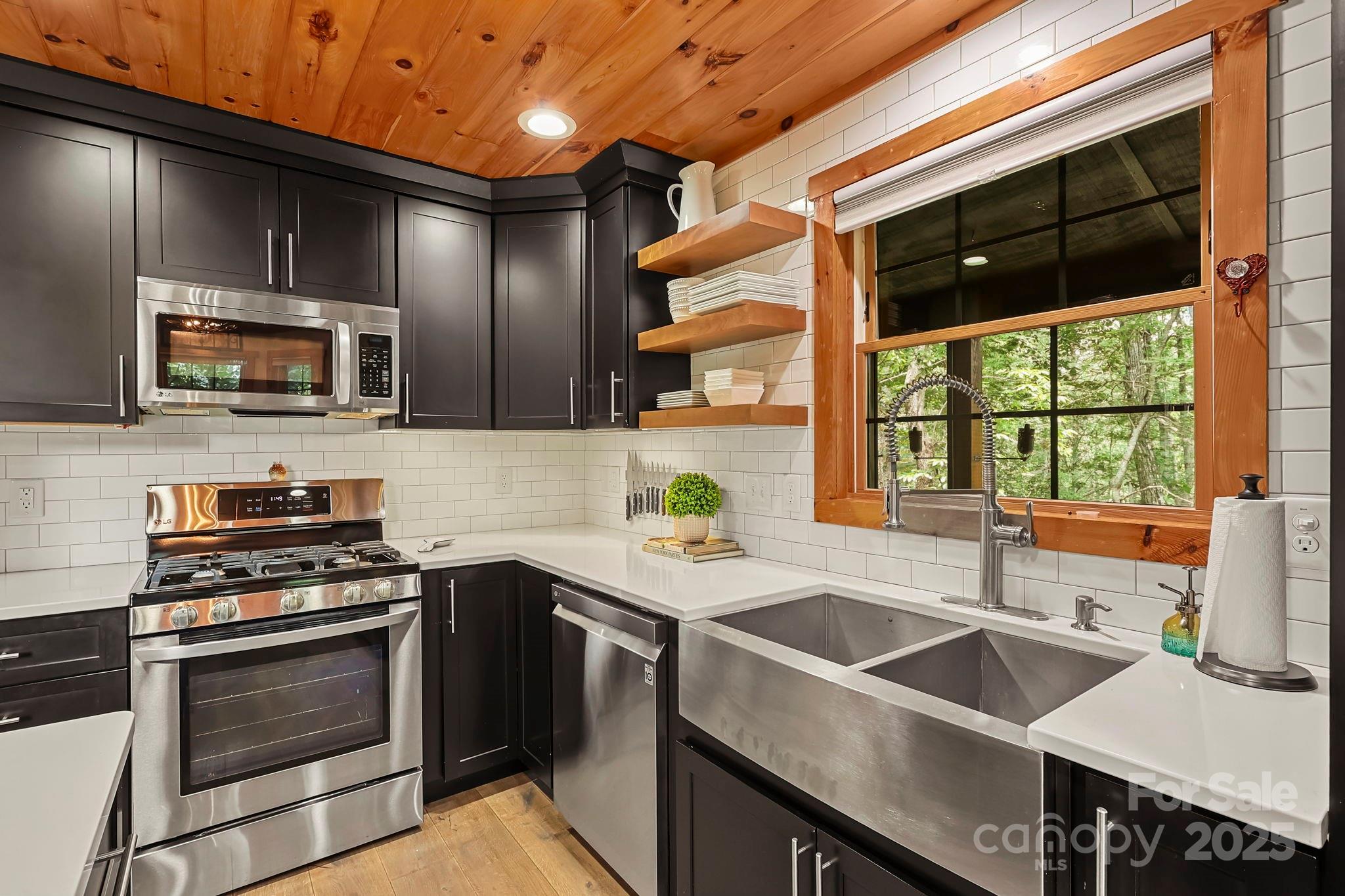 228 Woodby Ridge Road Vilas, NC 28692 - Photo 10 of 46 a kitchen that has a sink and a stove