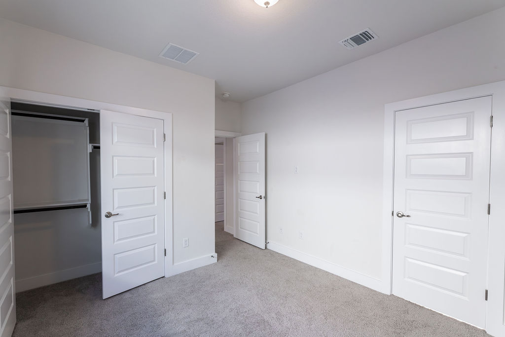 6414 Cowman Way Austin, TX 78747 - Photo 16 of 35 Soft carpeting pairs with crisp trim and smooth walls in this versatile secondary bedroom.