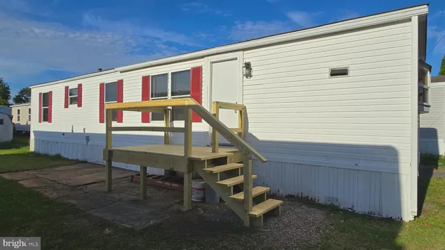 a front view of house with deck and outdoor seating