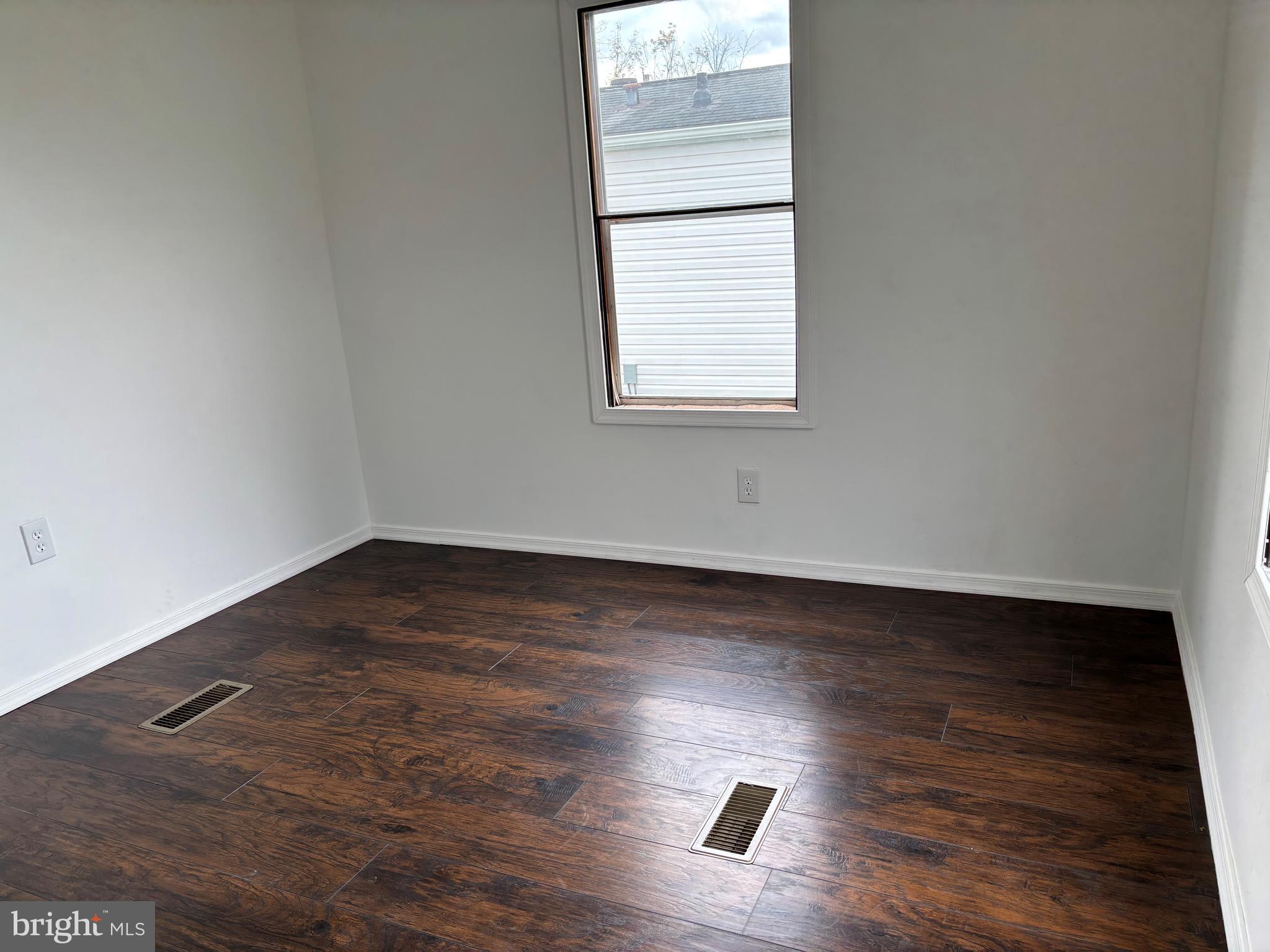 865 Cypress Ave Spring Spring City, PA 19475 - Photo 11 of 33 an empty room with wooden floor and windows
