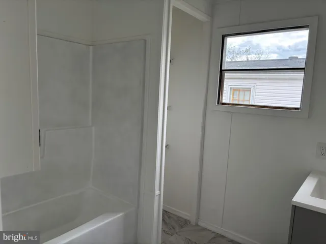 a bathroom with a sink and a window