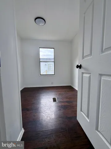 a bathroom with a toilet a sink a window and mirror