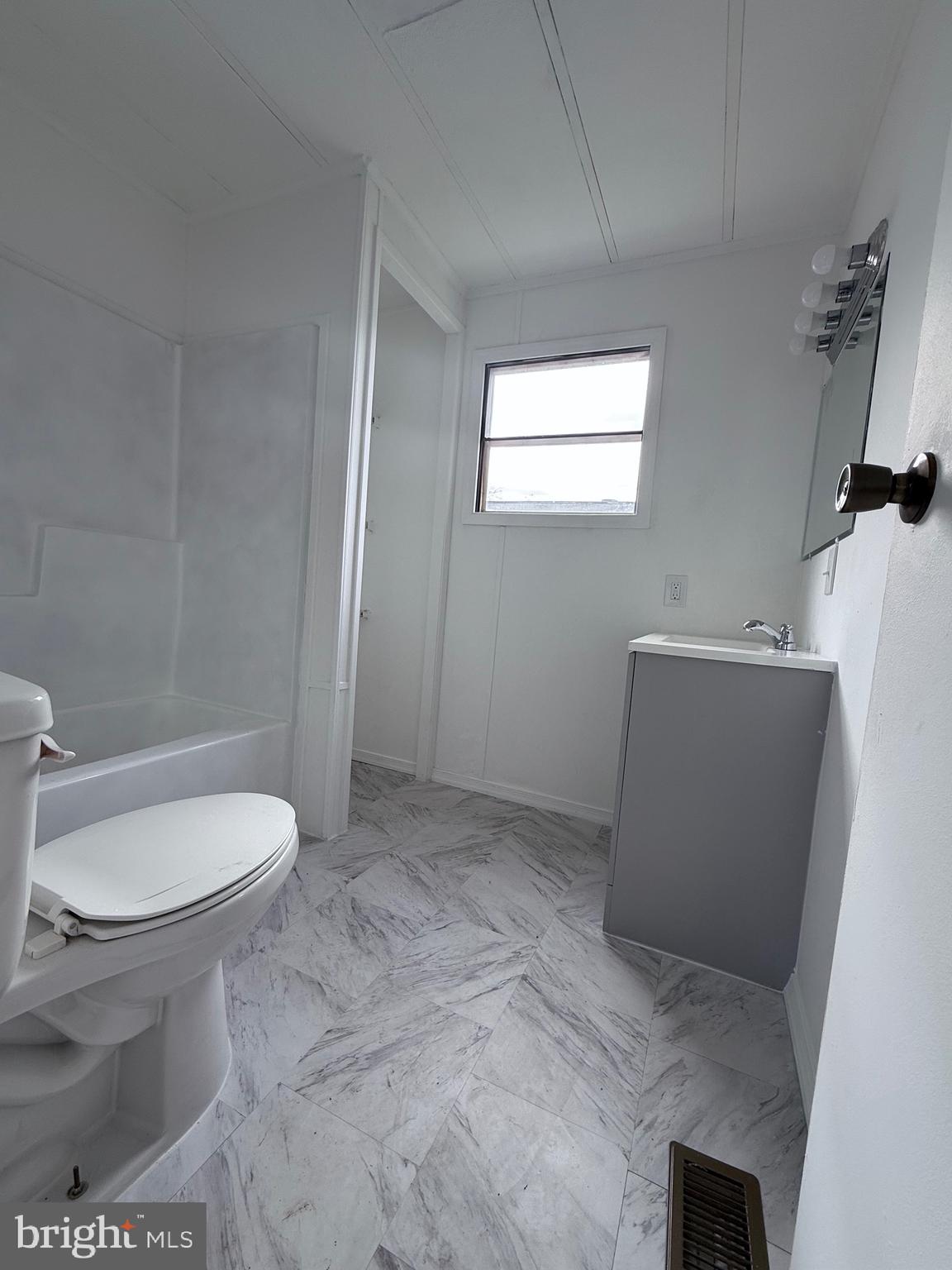 865 Cypress Ave Spring Spring City, PA 19475 - Photo 32 of 33 a bathroom with a toilet a sink a window and mirror