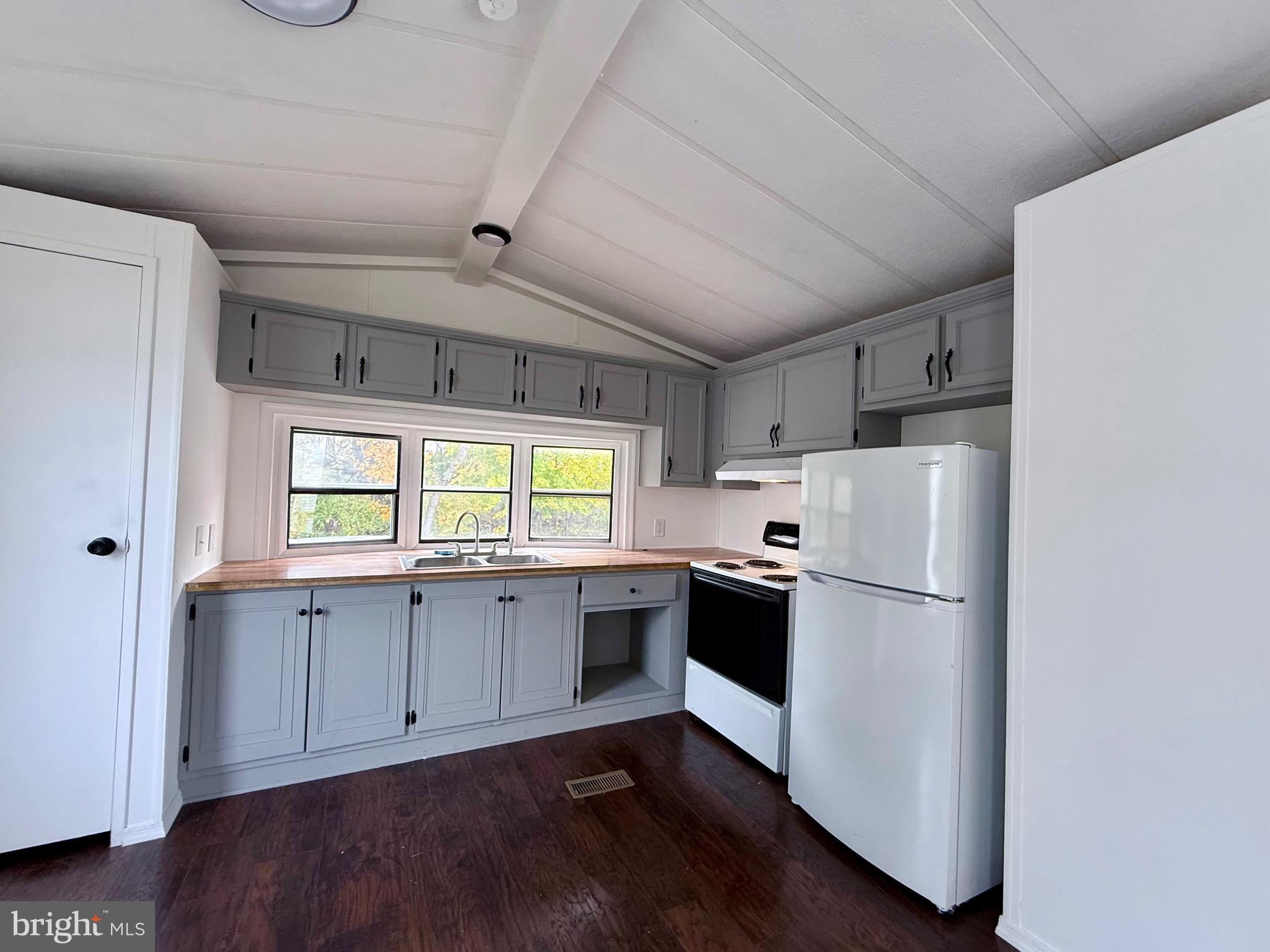 865 Cypress Ave Spring Spring City, PA 19475 - Photo 7 of 33 a kitchen with wooden cabinets and white appliances