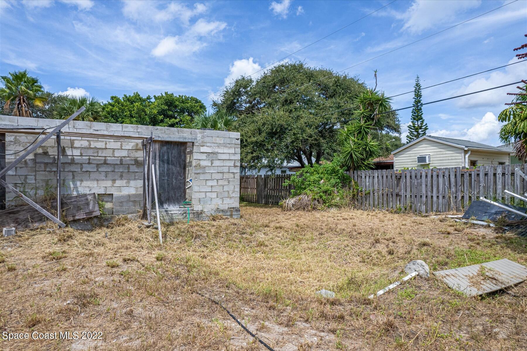 290 Rita Boulevard Melbourne Beach, FL 32951 - Photo 21 of 21 a view of a small yard in front of a house with wooden fence
