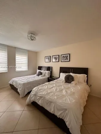 a bedroom with a bed and flat screen tv
