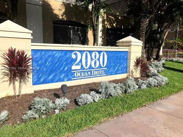 a sign broad in front of a white house