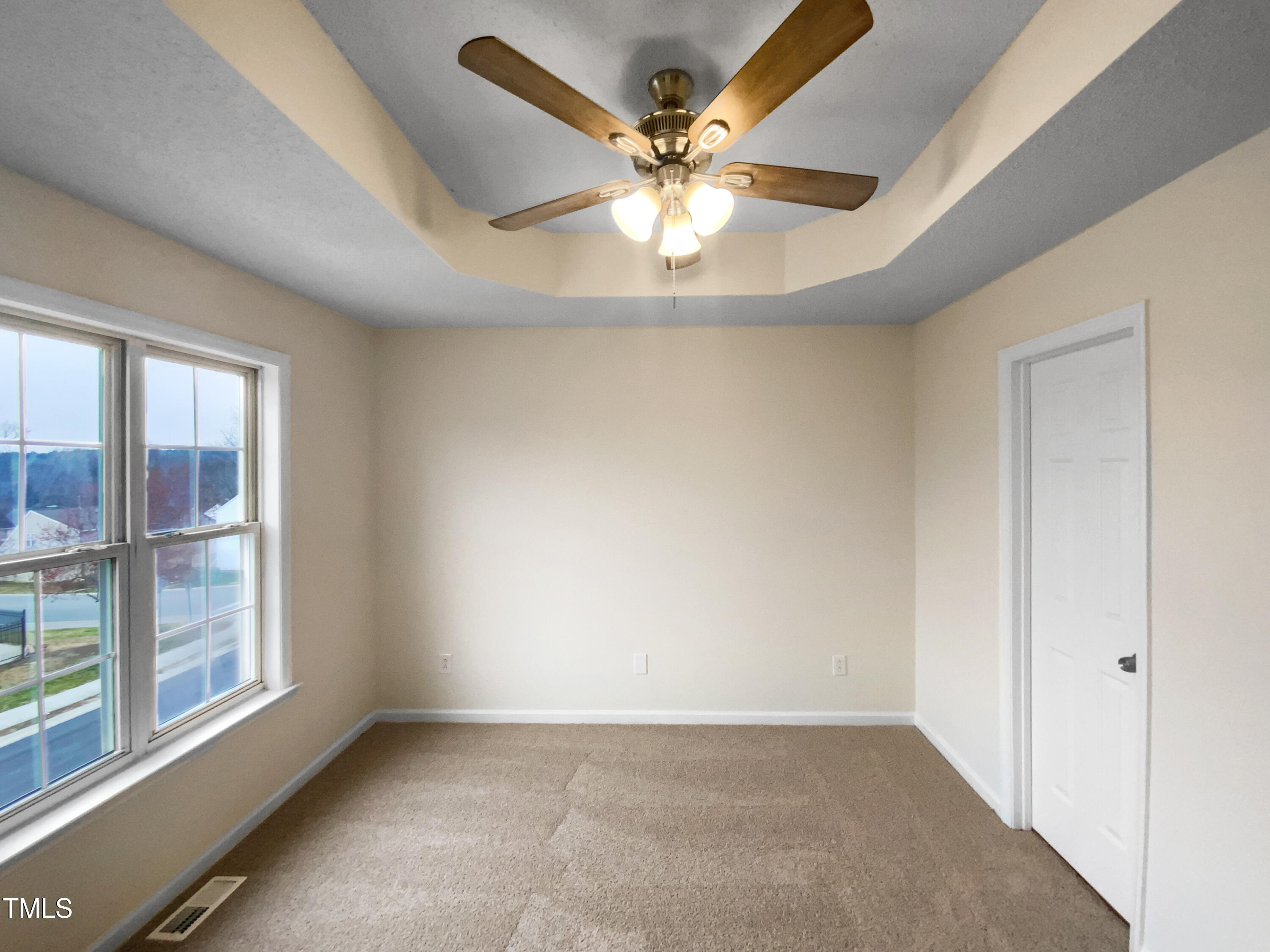 2013 Turtle Point Drive Raleigh, NC 27604 - Photo 10 of 20 an empty room with windows and ceiling fan